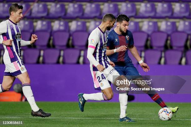 Rafa Mir of SD Huesca, Ruben Alcaraz of Real Valladolid, Joaquin Fernandez of Real Valladolid during the La Liga Santander match between Real...
