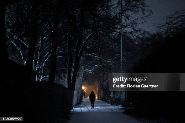 Woman is pictured during snowfall at Friday evening on January 29, 2021 in Berlin, Germany.