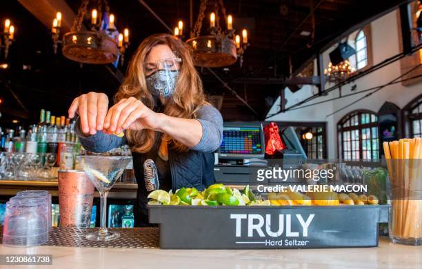 Bartender prepares some drinks at the outdoor seating area of The Abbey Food & Bar on January 29, 2021 in West Hollywood, California. - California...