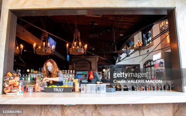 Bartender prepares some drinks at the outdoor seating area of The Abbey Food & Bar on January 29, 2021 in West Hollywood, California. - California...