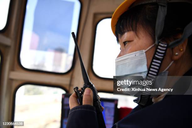 Jan. 29, 2021 -- Sun Hong operates a crane on a project of the subway Line No.5 in Hefei, capital of east China's Anhui Province, Jan. 28, 2021. Jia...