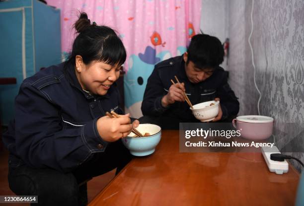 Jan. 29, 2021 -- Sun Hong L and Jia Deku have dinner at their dormitory in Hefei, capital of east China's Anhui Province, Jan. 28, 2021. Jia Deku and...