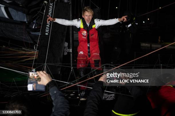 French skipper Maxime Sorel celebrates onboard his Imoca 60 monohull "V&B - Mayenne" after crossing the finish line of the Vendee Globe...