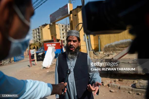 Sheikh Aslam, brother of Sheikh Adil, one of the accused of murdering US journalist Daniel Pearl, speaks with media representatives outside the...