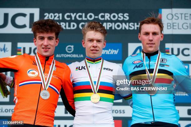 Dutch cyclist Pim Ronhaar stands with silver medallist defending champ Ryan Kamp and bronze medalist Belgium Timo Kielich during the medal ceremony...