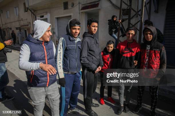 Group of teenagers of a tough neighborhood are seen in the street of the popular city of Ettadhamen, which is one of the most populated cities in the...