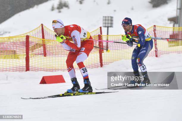 Szczepan Kupczak of Poland and Alessandro Pittin of Italy competes during the Men's Gundersen Normal Hill HS109/10.0 Km at the Viessmann FIS Nordic...