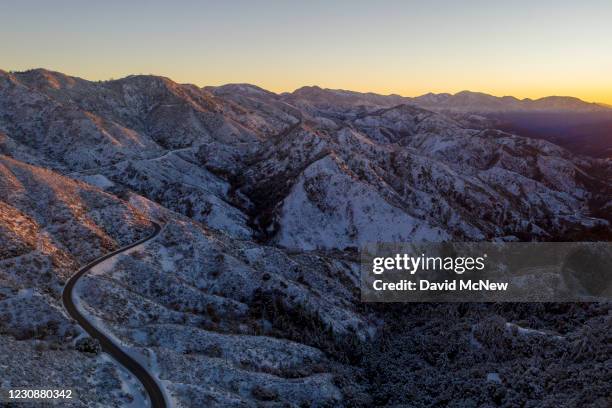 In an aerial view from a drone, fresh snow covers the San Gabriel Mountains on the morning after a winter storm breaks on January 30, 2021 near La...