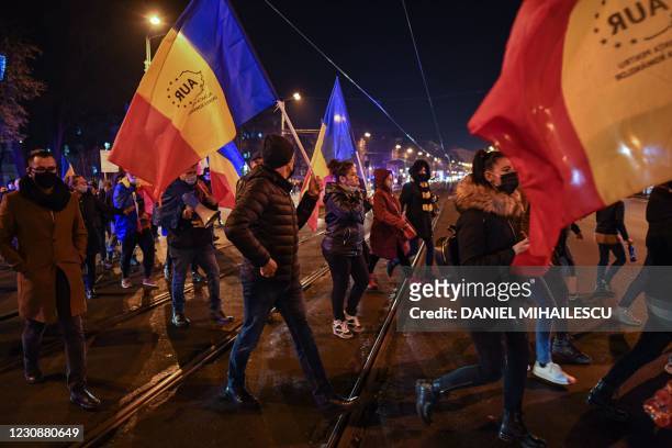 Supporters of nationalist parliamentary party AUR protest against the health ministry, in downtown Bucharest, on January 30, 2021. - Romania was in...