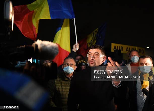 George Simion, the leader and parliament member of nationalist party AUR gestures during a protest against the health ministry, in downtown...