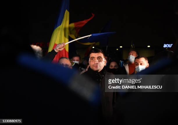 George Simion, the leader and parliament member of nationalist party AUR looks on during a protest against the health ministry, in downtown...