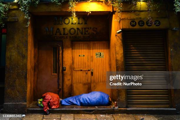 Rough sleeper seen at the entrance to a closed Molly Malones pub in Temple Bar, Dublin, during Level 5 Covid-19 lockdown. On Saturday, 30 January in...