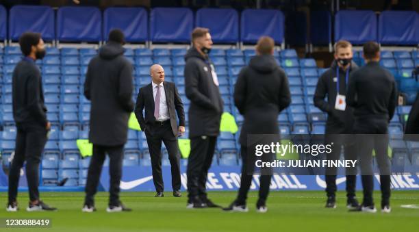 Burnley's English manager Sean Dyche stands on the pitch ahead of the English Premier League football match between Chelsea and Burnley at Stamford...