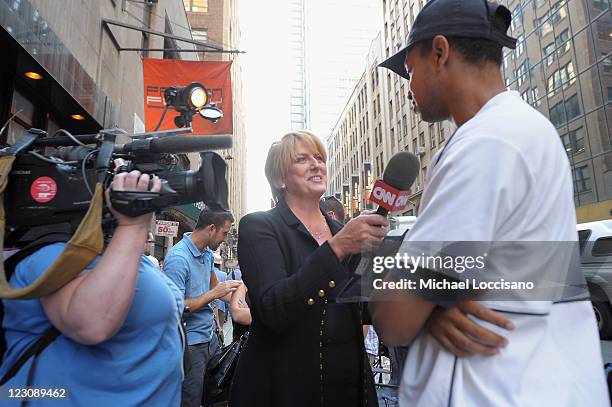 Anchor Felicia Taylor interviews a fan at DC Comics’ Midnight Madness Event celebrating the release of New No. 1 issue of "Justice League" at Mid...