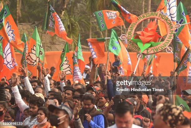 View of the crowd with BJP party flags during a rally at Dumurjala stadium, on January 31, 2021 in Howrah, India. On Saturday, five TMC leaders -...