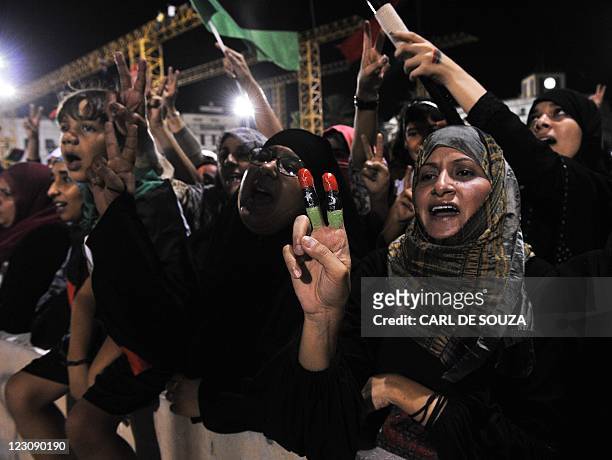 Woman with her fingers painted with the colours of the Libyan flag celebrates in Martyrs Square in Tripoli on August 30, 2011. Thousands of Libyans...