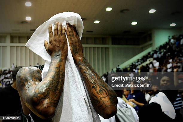 Carmelo Anthony wipes his face during the Goodman League All-Stars taking on The Melo League basketball game at Edward P. Hurt Gymnasium at Morgan...