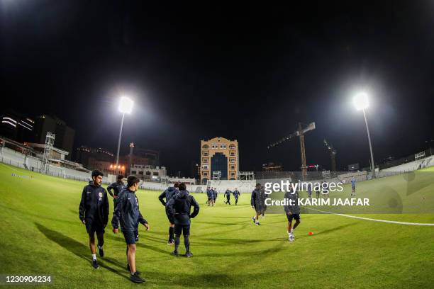 Players are pictured during a training session at the Doha Stadium in the Qatari capital, on December 29, 2020. - Away from the lavish air...
