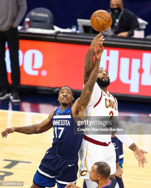 Ed Davis of the Minnesota Timberwolves and Andre Drummond of the Cleveland Cavaliers jump for the ball during the first quarter at Target Center on...
