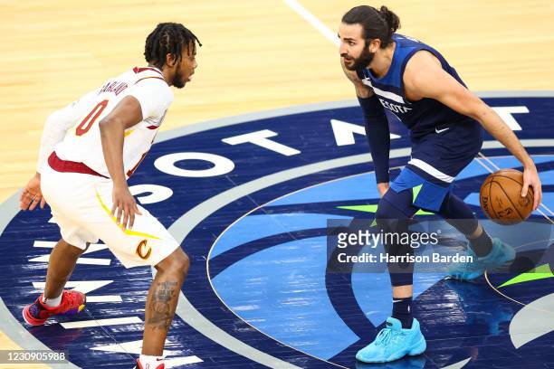 Ricky Rubio of the Minnesota Timberwolves dribbles the ball as Darius Garland of the Cleveland Cavaliers guards him during the third quarter at...
