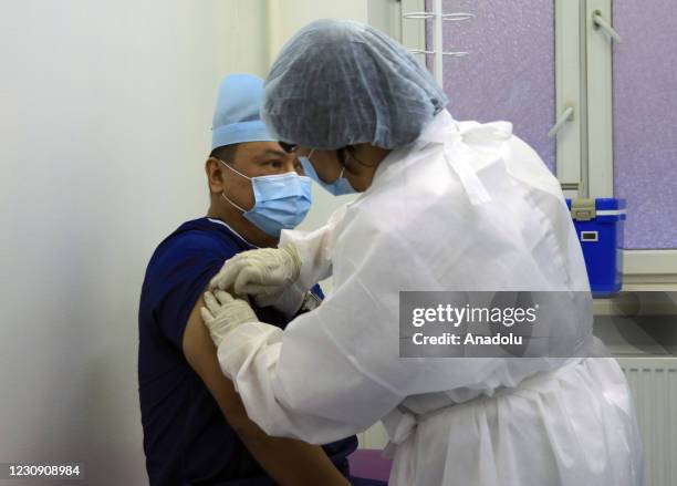 Deputy Minister of Health of Kazakhstan, Ajar Ginyat receives his first dose of the Sputnik V vaccine, manufactured by Biocad JSC, during a...