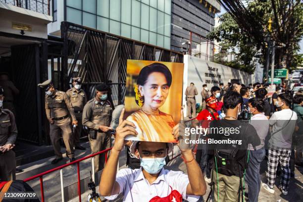 Demonstrator hold up images of Aung San Suu Kyi during a protest outside the Embassy of Myanmar in Bangkok, Thailand, on Monday, Feb. 1 2021....