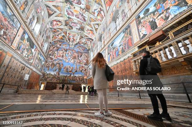 People visit the Sistine Chapel on the reopening day of the Vatican museum on February 1, 2021 in Vatican City, as the city-state eases its closure...