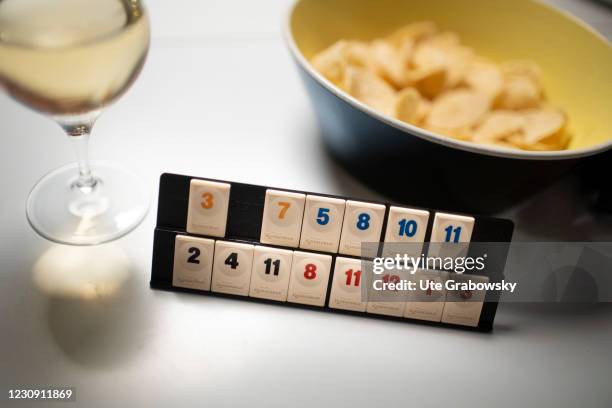 Bonn, Germany In this photo illustration a parlor game, wine and chips on a table in times of the corona lockdown on January 31, 2021 in Bonn,...