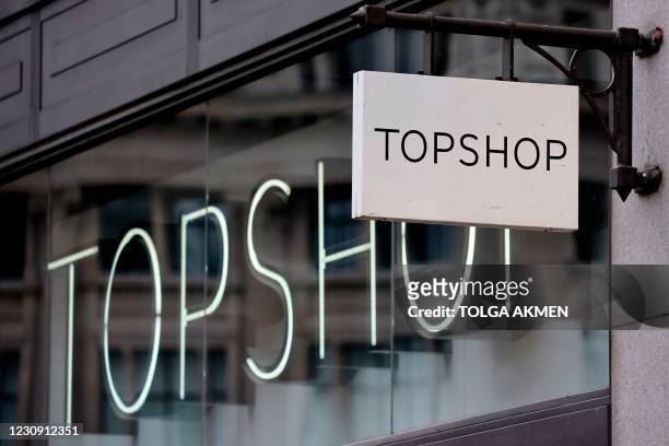 Sign is pictured outside a closed branch of the fashion retailer Topshop in central London on February 1, 2021. - Online clothing retailer ASOS...