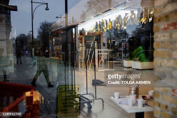 The deserted interior of a closed-down Topshop fashion store is pictured trough a window in London on February 1, 2021. - Online clothing retailer...