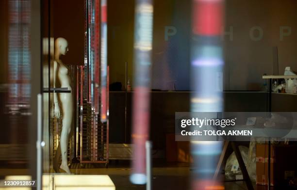 Mannequin is pictured inside a deserted, closed-down branch of the fashion retailer Topshop in central London on February 1, 2021. - Online clothing...