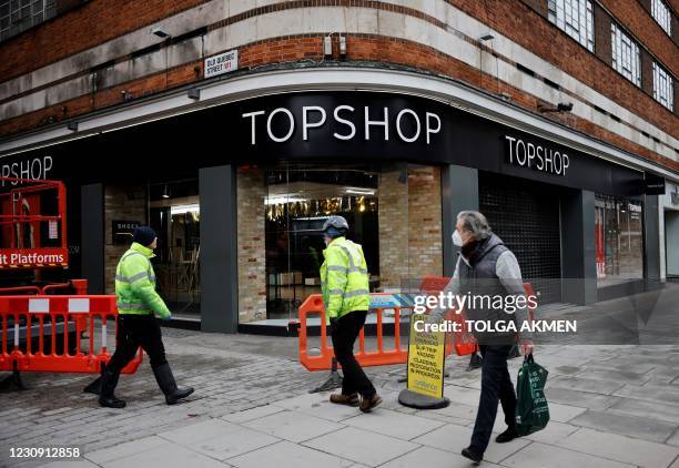 Pedestrian passes a closed branch of the fashion retailer Topshop in central London on February 1, 2021. - Online clothing retailer ASOS bought...