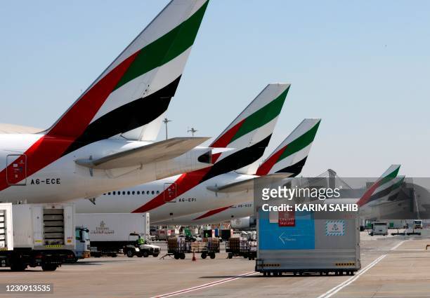 An Emirates Airlines Boing 777 plane unload a coronavirus vaccine shipment at Dubai International Airport on February 1, 2021 as key transport hub...