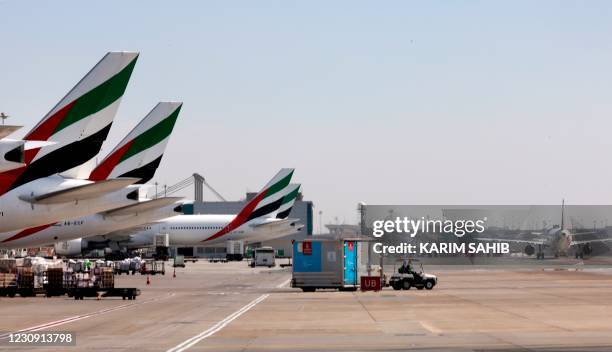 An Emirates Airlines Boing 777 plane unload a coronavirus vaccine shipment at Dubai International Airport on February 1, 2021 as key transport hub...