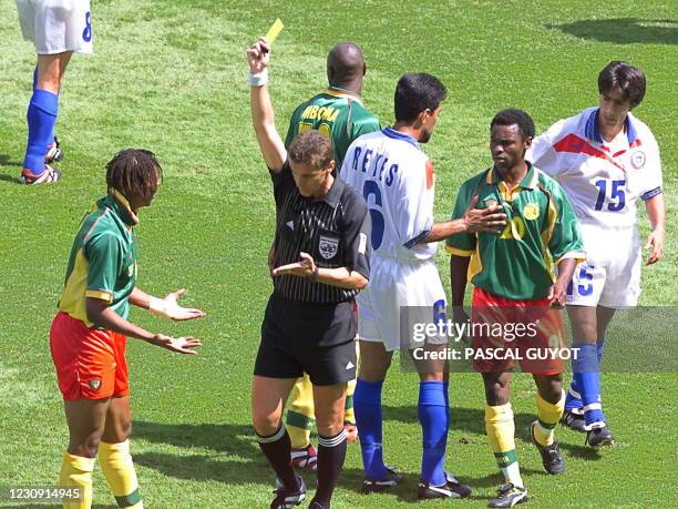 Cameroonian defender Rigobert Song receives a second yellow card received by Hungarian referee Lazlo Vagner 23 June during the 1998 Soccer World Cup...