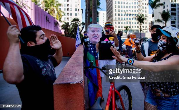 Trump supporter, left, clashes with anti -Trump supporters as members of Refuse Fascism demonstrate to denounce Wednesdays insurrection at the U.S....