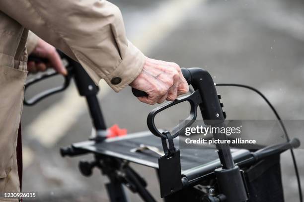 February 2021, Berlin: An elderly person is walking with a walker. Photo: Kira Hofmann/dpa-Zentralbild/dpa