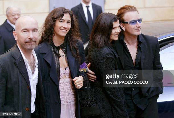 Guitar player for the rock group U2, The Edge poses flanked by his wife Morleigh Steinberg and Irish singer Bono with his wife Alison Steward after...
