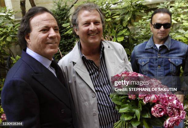 Le chanteur espagnol Julio Iglesias pose avec un bouquet de roses à son nom, aux côté de son créateur Jacques Mouchotte , lors d'une présentation de...