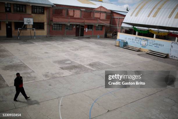 Man walks through an empty soccer field at Unidad educativa 1 de Mayo on February 2, 2021 in El Alto, Bolivia. Despite classes officially started on...
