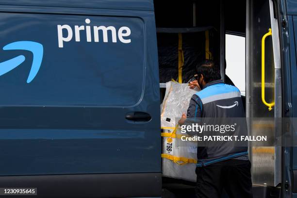 An Amazon.com Inc. Delivery driver loads a van outside of a distribution facility on February 2, 2021 in Hawthorne, California. - Jeff Bezos said...