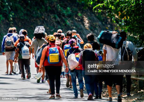 Venezuelan migrants walk along a highway in Cucuta, Colombia, on the border with Venezuela, on February 2 amid the COVID-19 pandemic.