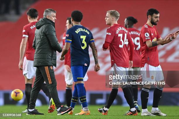 Manchester United's Norwegian manager Ole Gunnar Solskjaer congratulates his players on the pitch after the English Premier League football match...