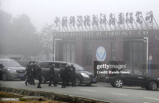 Motorcade carrying members of the World Health Organization's team investigating the origins of the coronavirus pandemic arrives at the Wuhan...