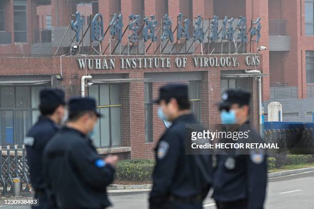 Security personnel stand guard outside the Wuhan Institute of Virology in Wuhan as members of the World Health Organization team investigating the...
