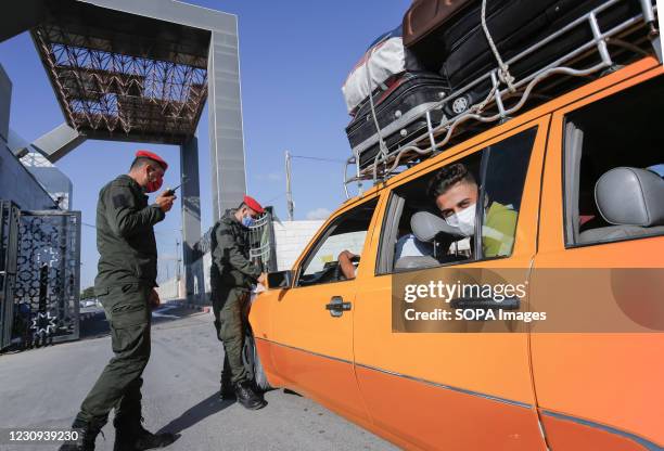 Palestinian security forces inspect vehicles carrying passengers at the Rafah land crossing after Egypt announced that it would reopen the border...