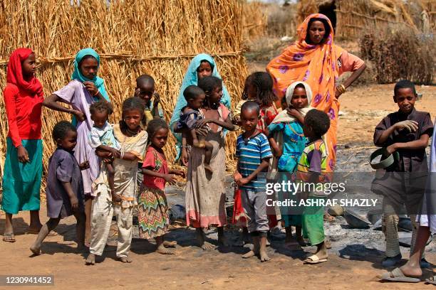 Sudanese children gather near the remains of burnt shacks in the aftermath of violence in the village of Twail Saadoun, 85 kilometres south of Nyala...