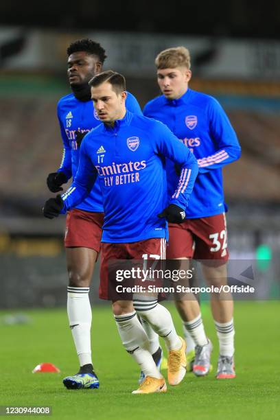 Cedric Soares of Arsenal warms up with Thomas Partey of Arsenal and Emile Smith Rowe of Arsenal before the Premier League match between Wolverhampton...