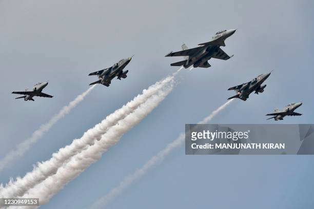Sukhoi Su-30MKI fighters and Hawk aircrafts belonging to the India Airforce fly in formation on the inaugural day of the five-day Aero India 2019...