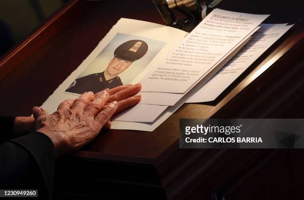 House of Representatives Speaker Nancy Pelosi holds a portrait of late Capitol Police officer Brian Sicknick as he lies in honor during a ceremony as...